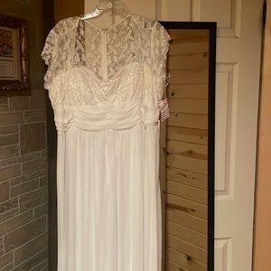 Wedding dress never worn still has tags on it. Could use a good dry cleaning.